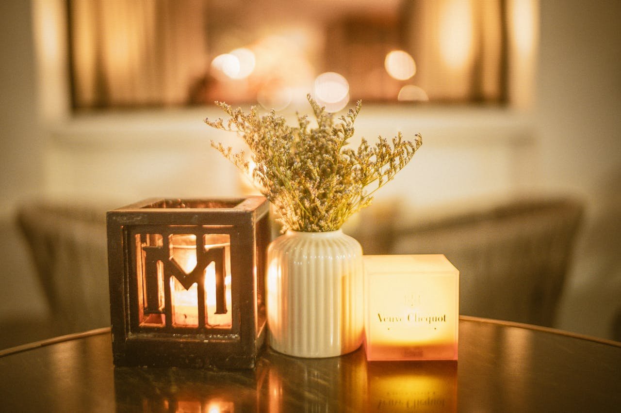 Warm candlelit table setting with elegant floral arrangement and glowing ambiance.